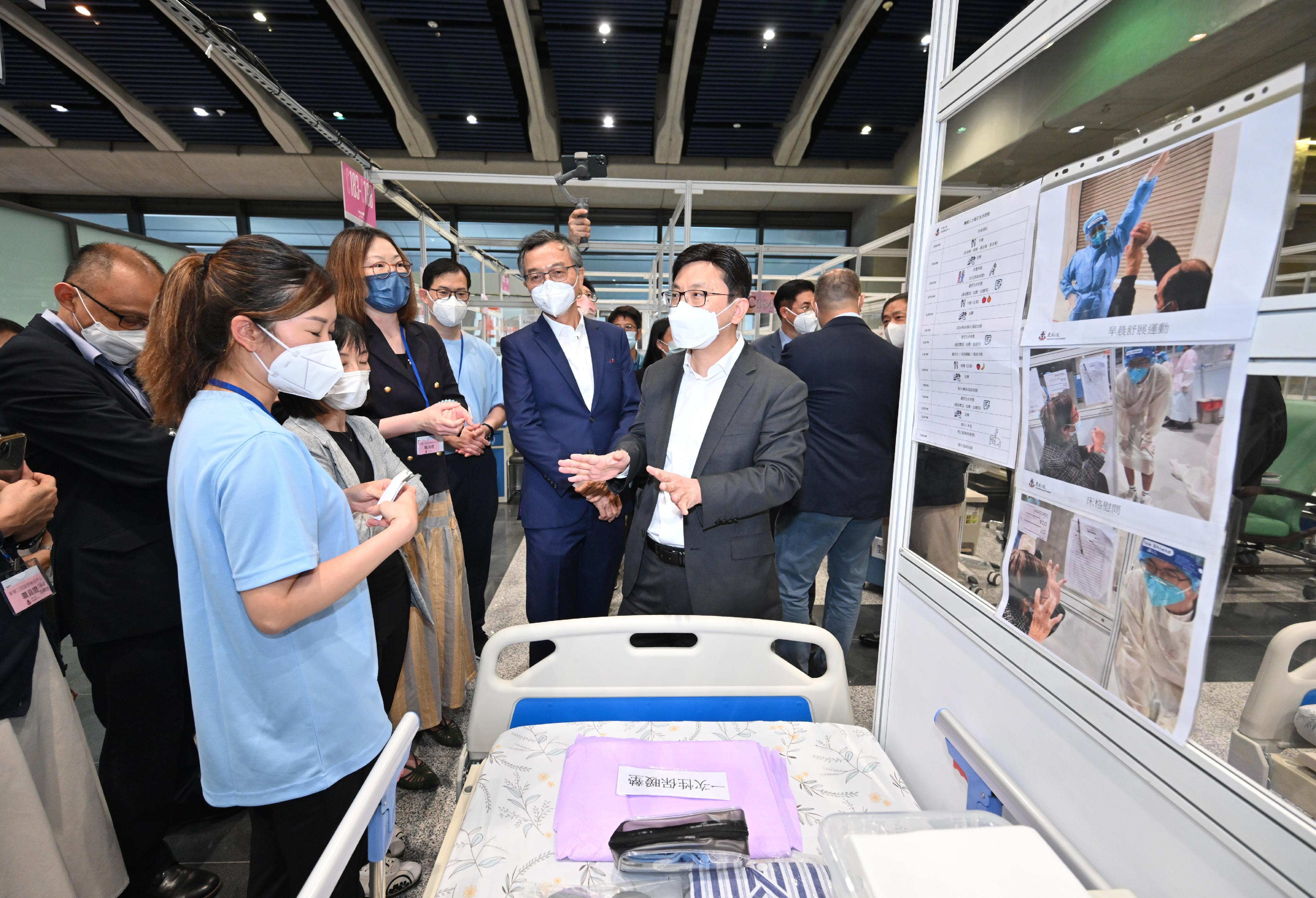 The Secretary for Labour and Welfare, Mr Chris Sun, today (September 1) visited the Kai Tak Quarantine Centre at the Kai Tak Cruise Terminal to learn more about the preparatory work prior to its commencement of operation tomorrow (September 2). Photo shows Mr Sun (front row, first right) being updated by a staff member of the care team on the care services to the elderly during their stay.